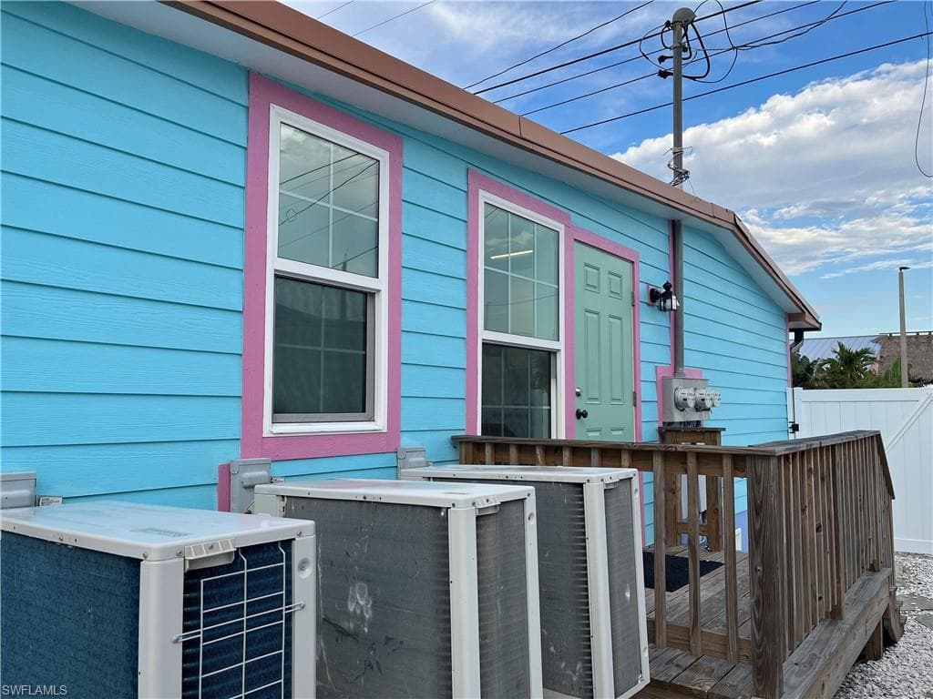 View of side of home featuring a deck and a central air condition unit