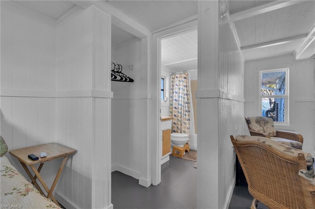 Bathroom featuring a shower with shower curtain and toilet