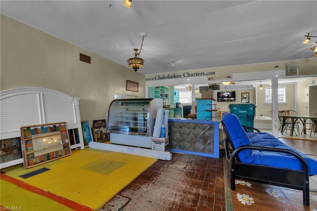 Living area with custom floor and visible vents