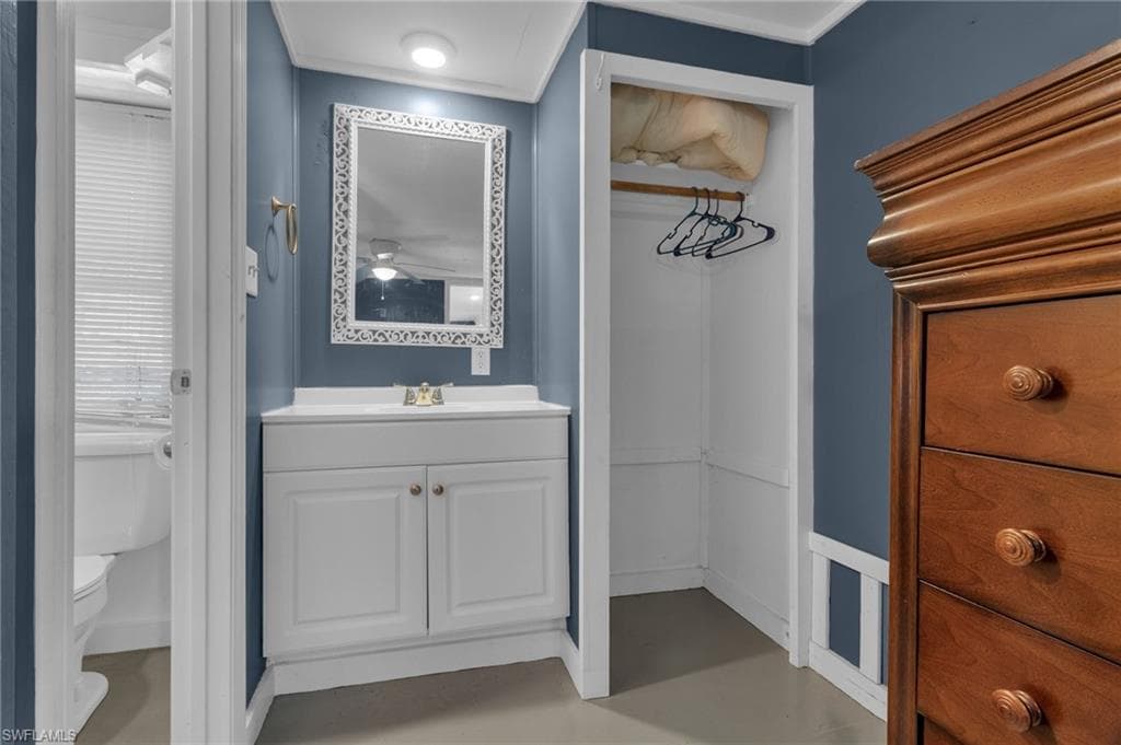 Bathroom, flooring, vanity, and toilet