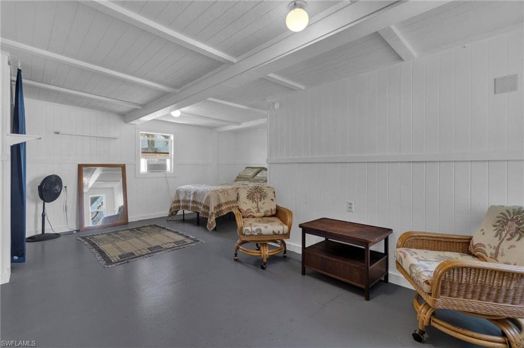 Living area with beamed ceiling and cooling unit