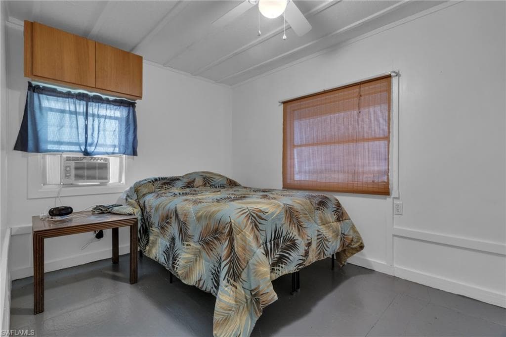 Bedroom featuring wood floors, cooling unit, and ceiling fan