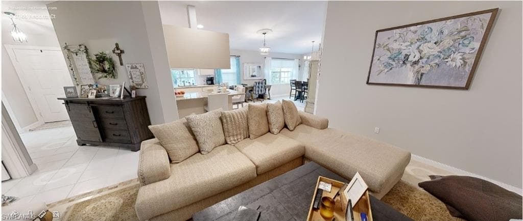 Living room featuring tile patterned floors and baseboards