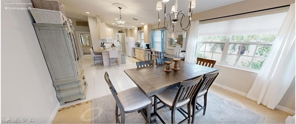 Dining space with a chandelier, recessed lighting, and light tile patterned flooring