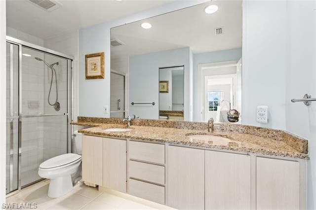 Bathroom featuring double vanity, visible vents, and a sink