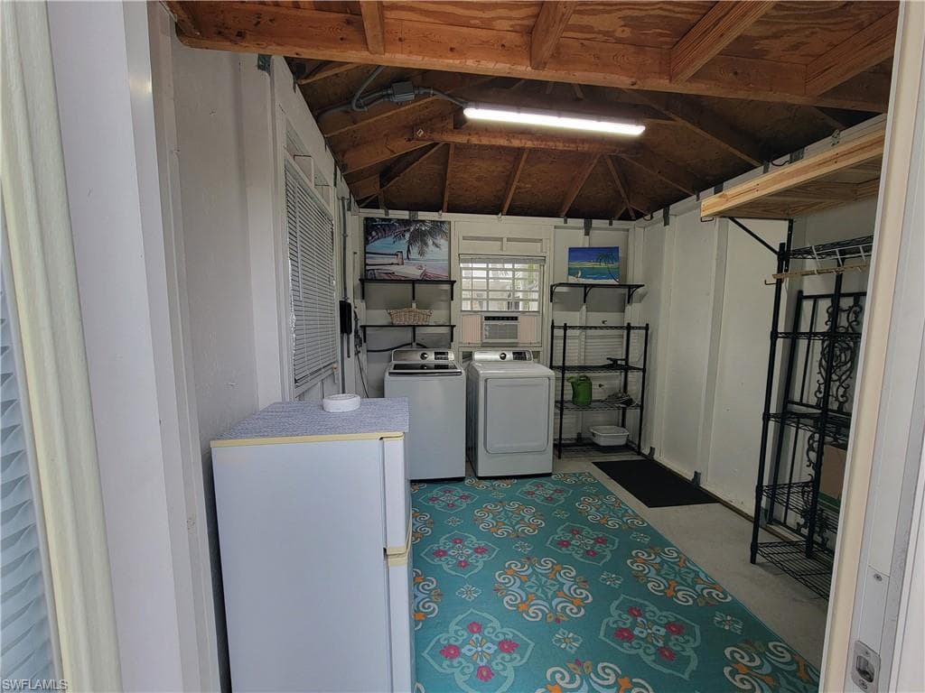 Below grade area featuring washer and clothes dryer and cooling unit