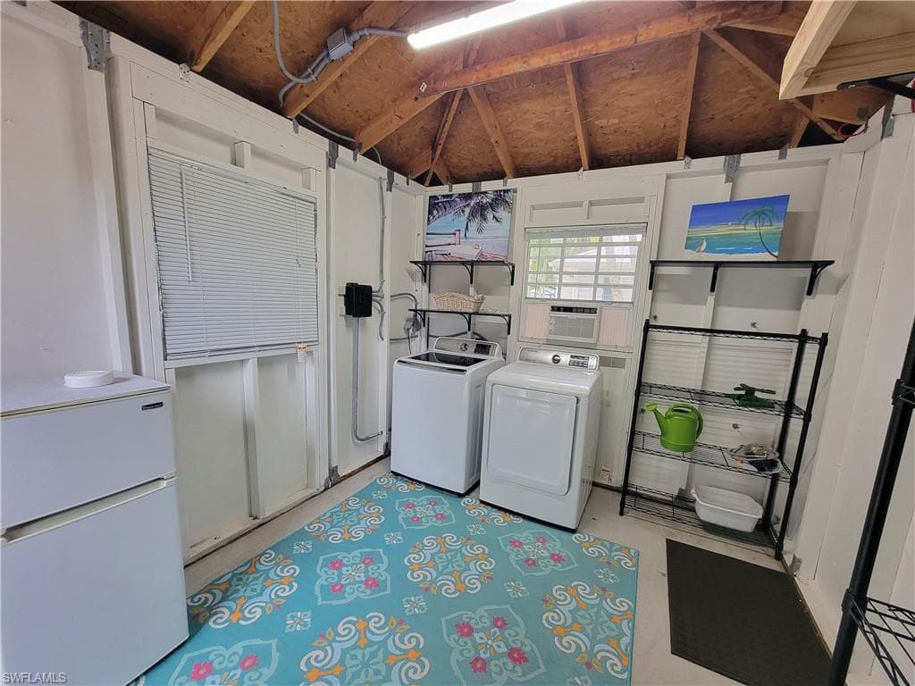 Laundry room with washing machine and dryer and cooling unit