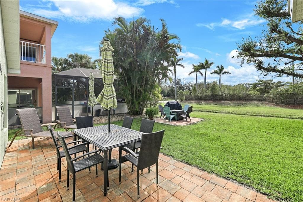 View of patio / terrace with a lanai and outdoor dining area