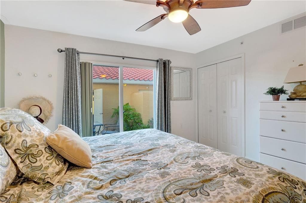 Bedroom with a ceiling fan, access to outside, a closet, and visible vents