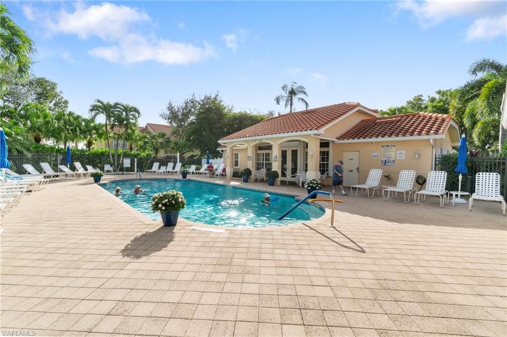Pool featuring a patio area, french doors, and fence