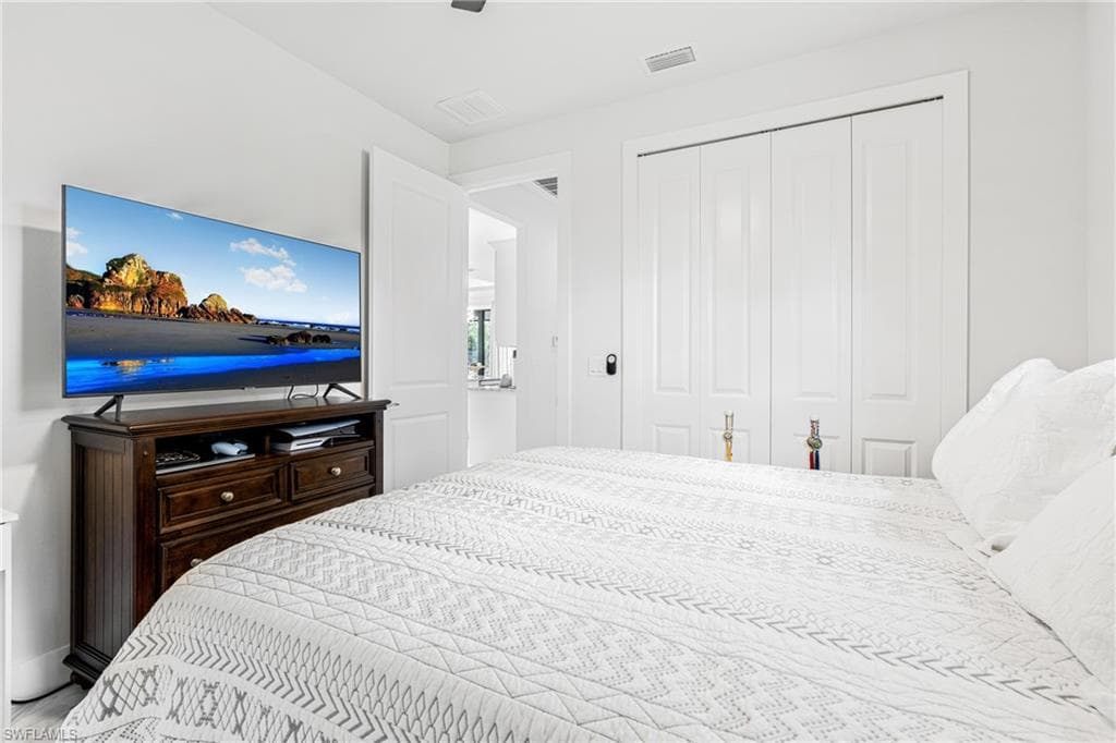 Bedroom featuring visible vents and a closet