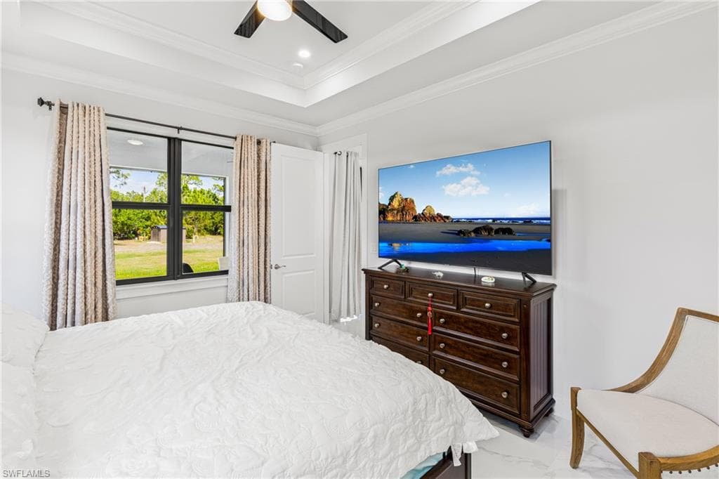 Bedroom featuring marble finish floor, recessed lighting, a raised ceiling, ornamental molding, and ceiling fan