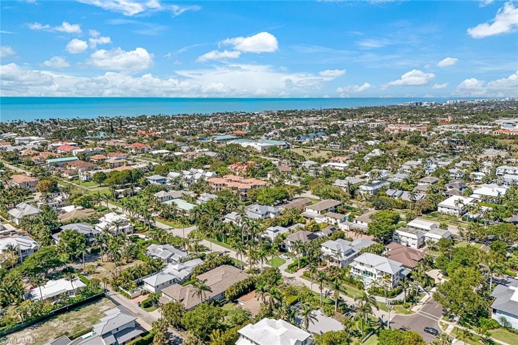 Birds eye view of property with a residential view and a water view