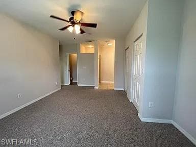 Unfurnished bedroom with carpet flooring, baseboards, and ceiling fan