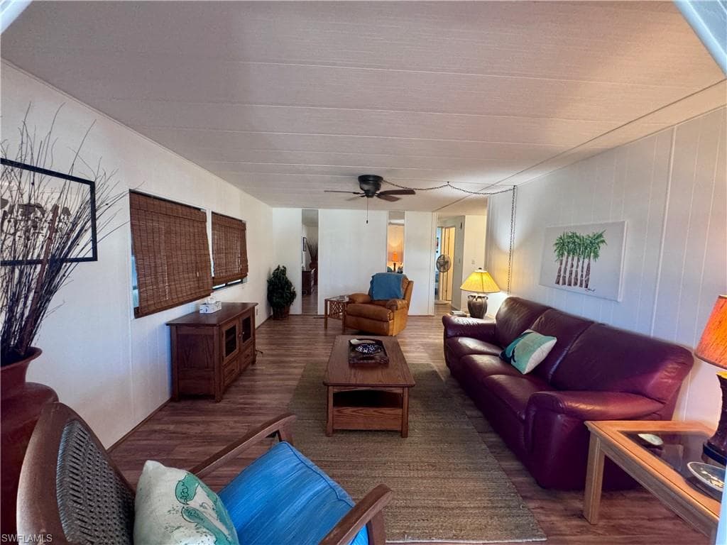 Living room with a ceiling fan and wood finished floors