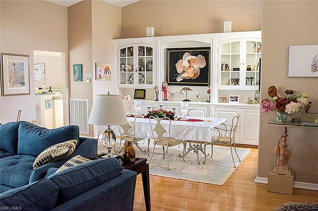 Dining space with wood finished floors and built-in buffet and china cabinet.