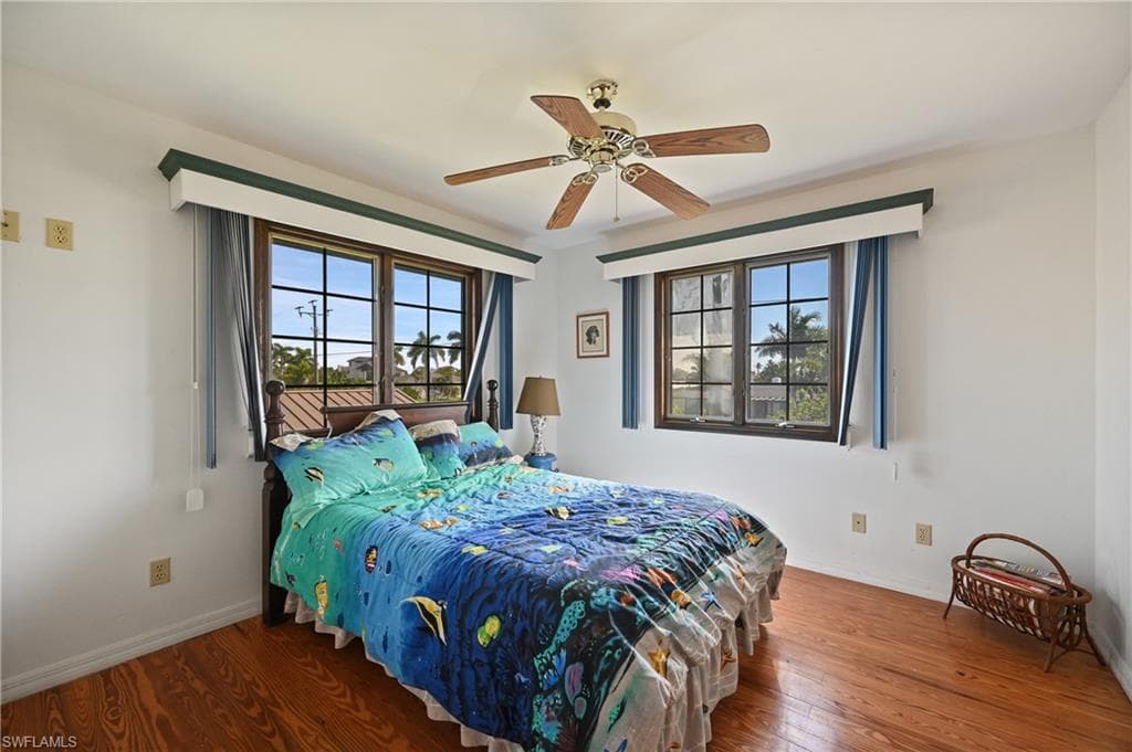 Bedroom with wood finished floors and ceiling fan