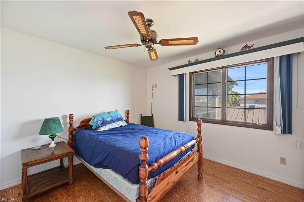 Bedroom with wood finished floors and ceiling fan