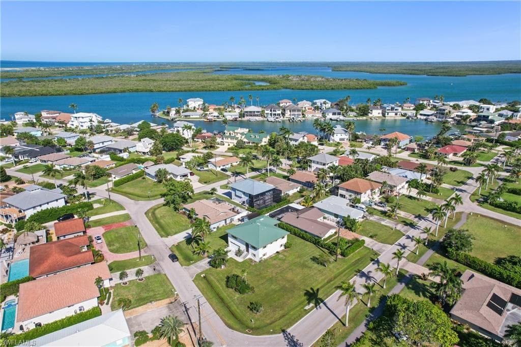 View of property location featuring a nearby body of water and nearby suburban area