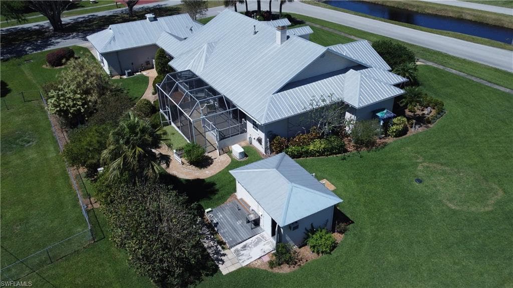 Birds eye view of property with a water view