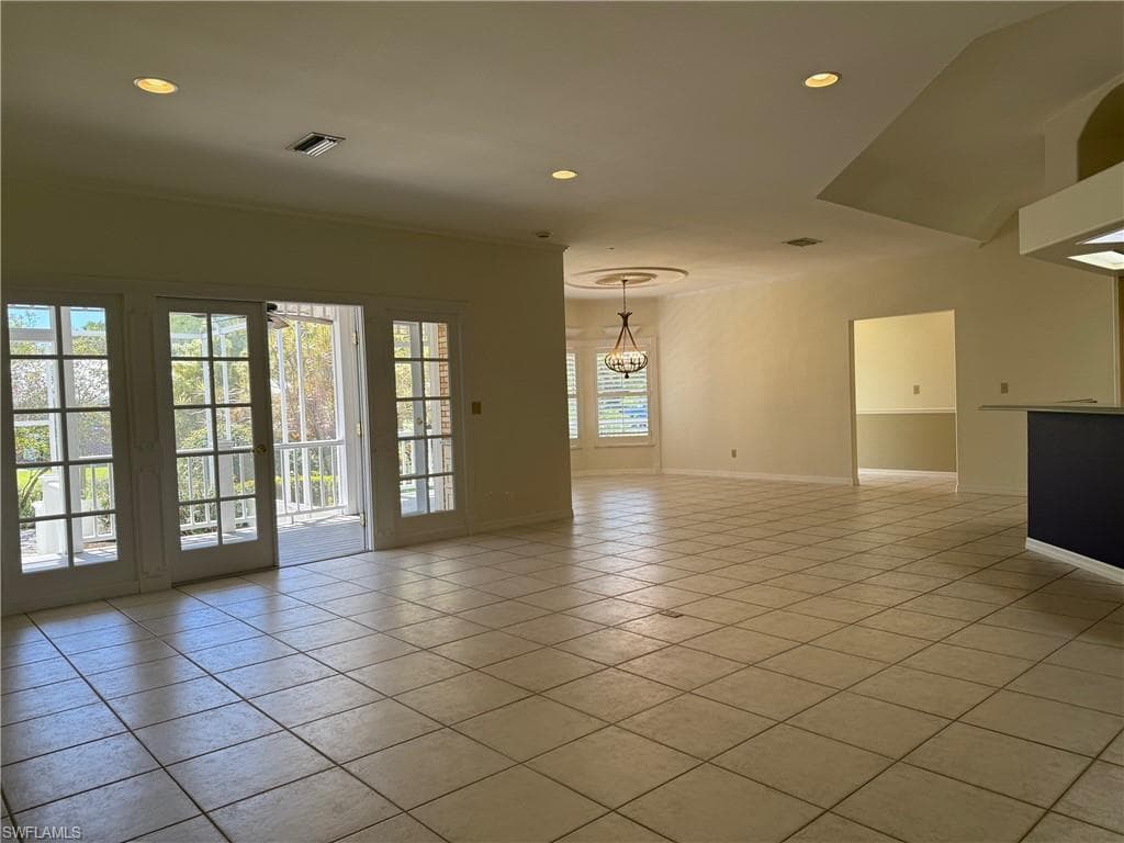 Empty room featuring visible vents, baseboards, an inviting chandelier, light tile patterned flooring, and recessed lighting