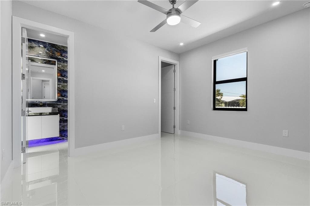 Empty room featuring tile patterned flooring, recessed lighting, and a ceiling fan