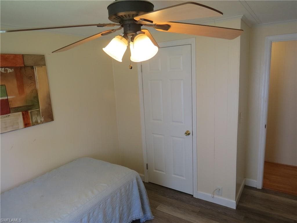 Bedroom with wood finished floors and a ceiling fan
