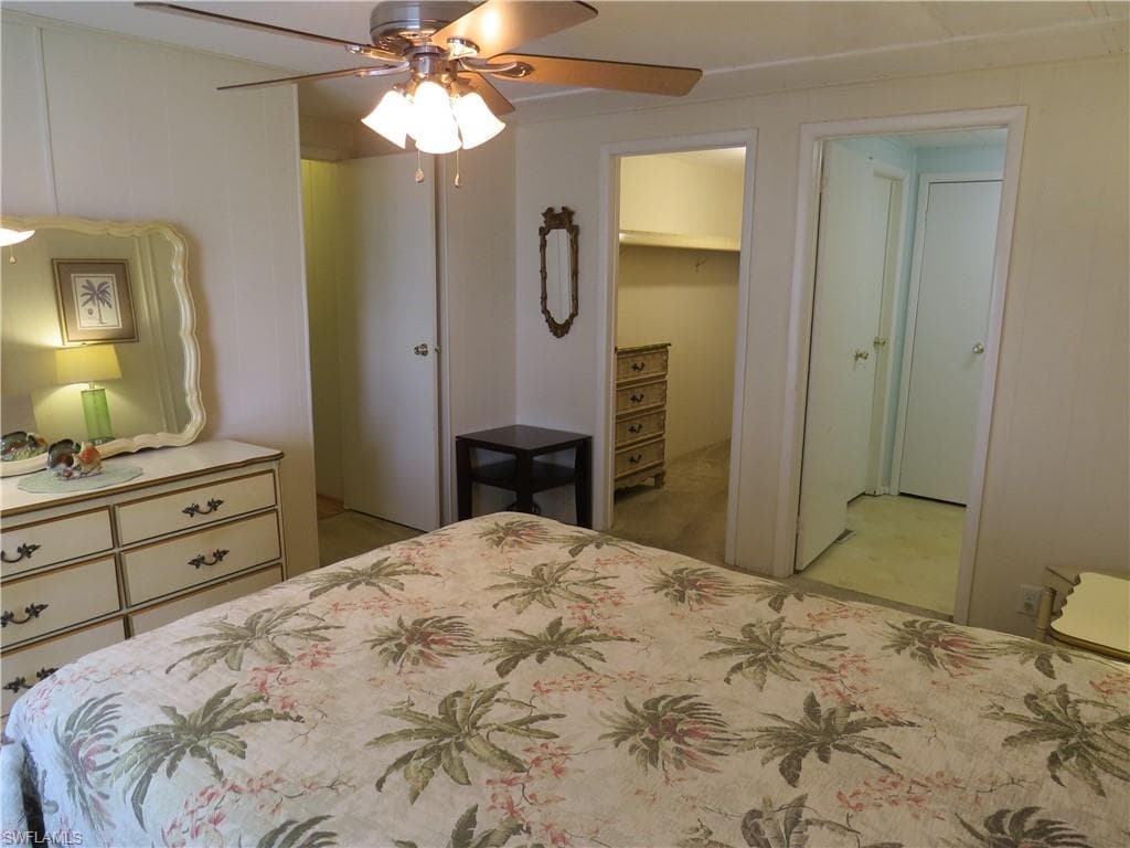 Bedroom featuring a ceiling fan, a closet, and light colored carpet