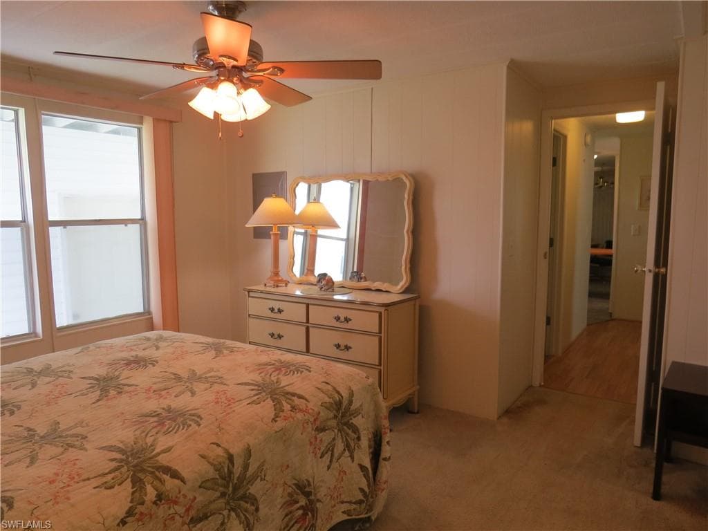 Bedroom featuring light carpet and a ceiling fan