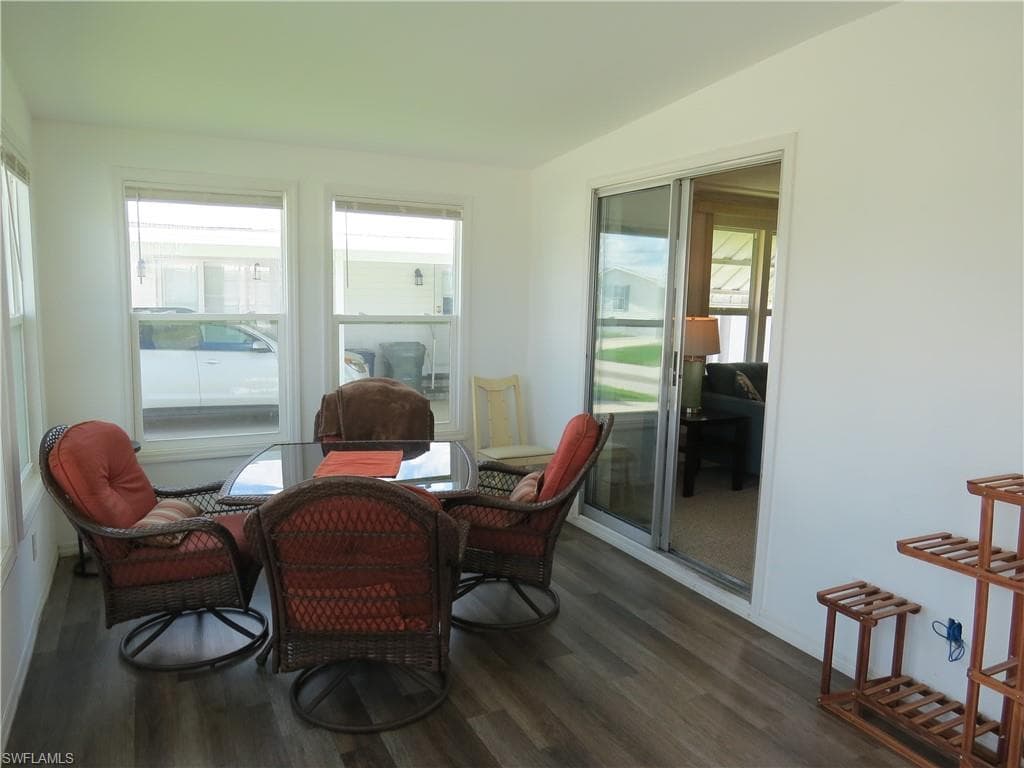 Sunroom with plenty of natural light and wood finished floors