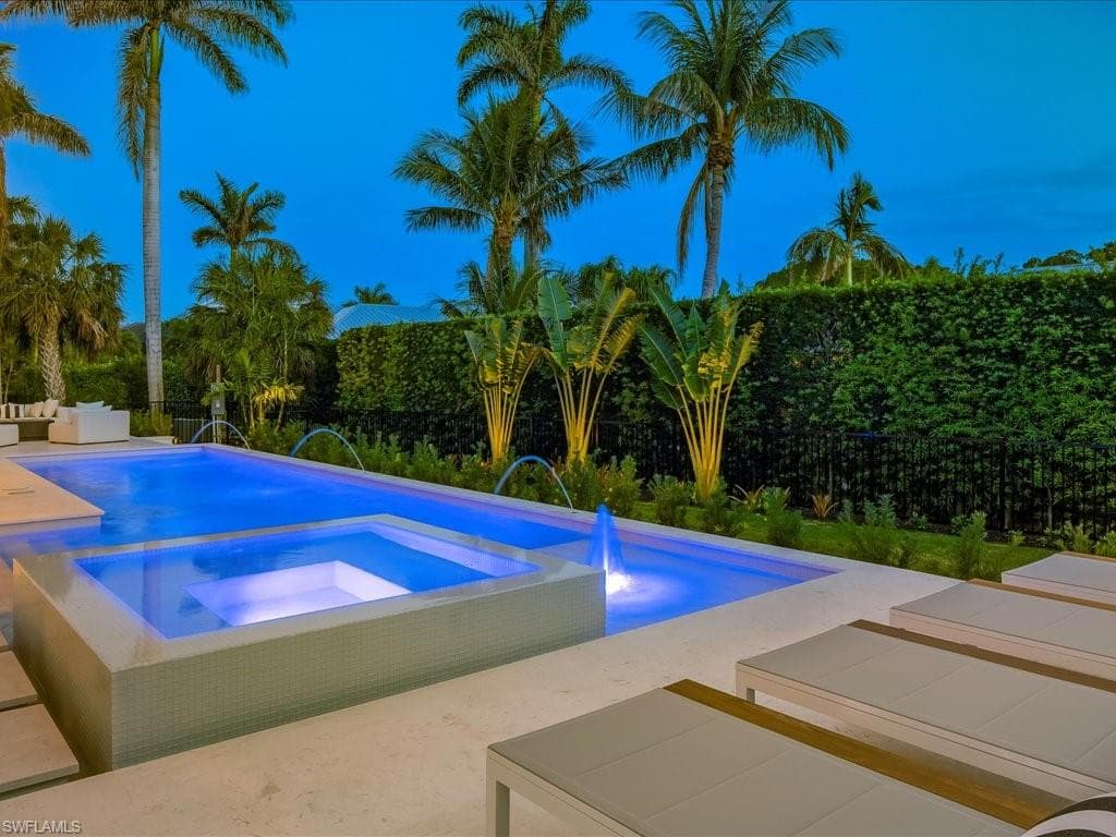 View of pool with a fenced backyard, an in ground hot tub, and a patio area