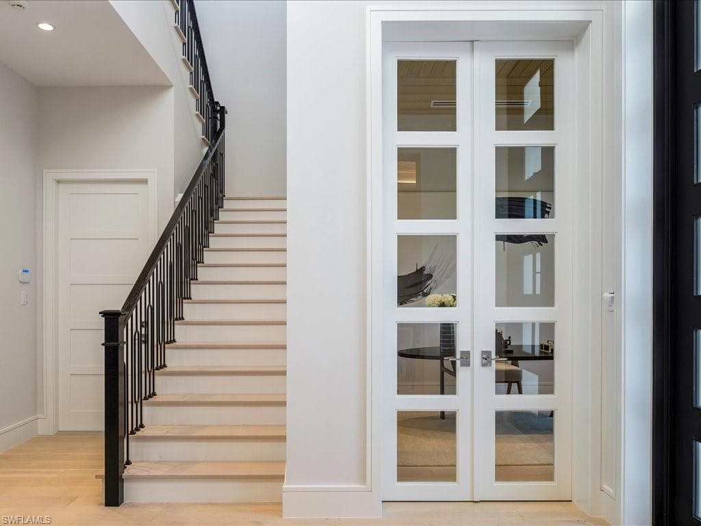 Staircase featuring french doors, recessed lighting, baseboards, and wood finished floors