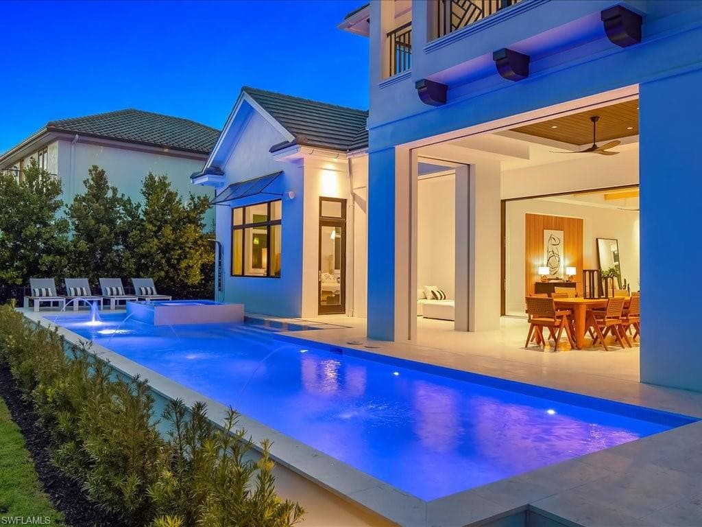 Pool featuring a jacuzzi, outdoor dining space, and a patio area