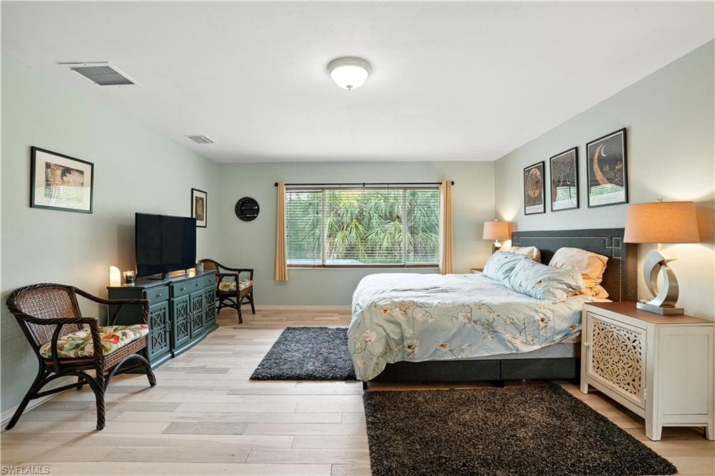 ChatGPT said:Spacious primary bedroom with large window framing serene preserve views, filling the room with natural light. Soft neutral tones, warm wood-look flooring, and modern lighting create a calm and inviting retreat. Ample space for a king bed and seating area makes it perfect for relaxing after a long day. Ideal for Southwest Florida living, this peaceful suite offers privacy, comfort, and style—just minutes from Gulf beaches, shopping, and dining.