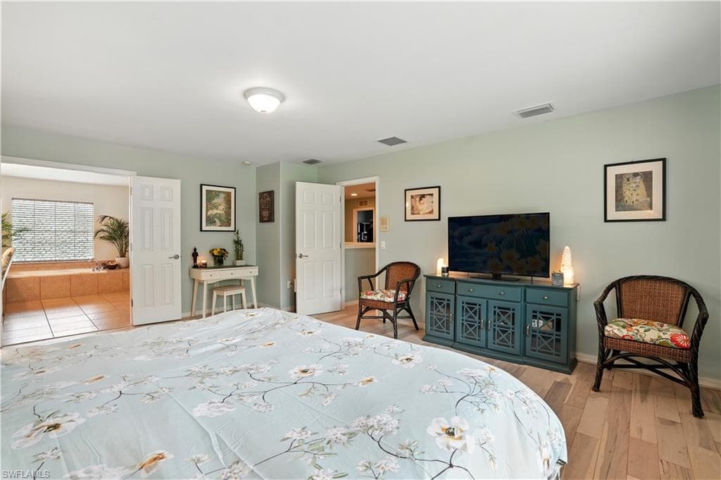 ChatGPT said:Spacious primary bedroom with large window framing serene preserve views, filling the room with natural light. Soft neutral tones, warm wood-look flooring, and modern lighting create a calm and inviting retreat. Ample space for a king bed and seating area makes it perfect for relaxing after a long day. Ideal for Southwest Florida living, this peaceful suite offers privacy, comfort, and style—just minutes from Gulf beaches, shopping, and dining.