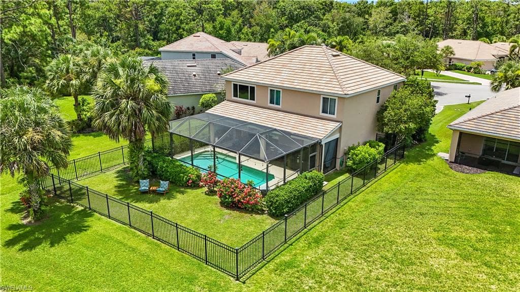 Beautifully landscaped backyard with lush greenery, mature palms, and a fully fenced yard for privacy and pets. The screened-in pool and spacious patio create a private oasis perfect for entertaining or relaxing. Backing onto a serene preserve, this two-story Florida home offers stunning views and outdoor living at its finest. Located on a quiet cul-de-sac, it’s minutes from Gulf beaches, shopping, and dining—ideal for enjoying Southwest Florida’s lifestyle.