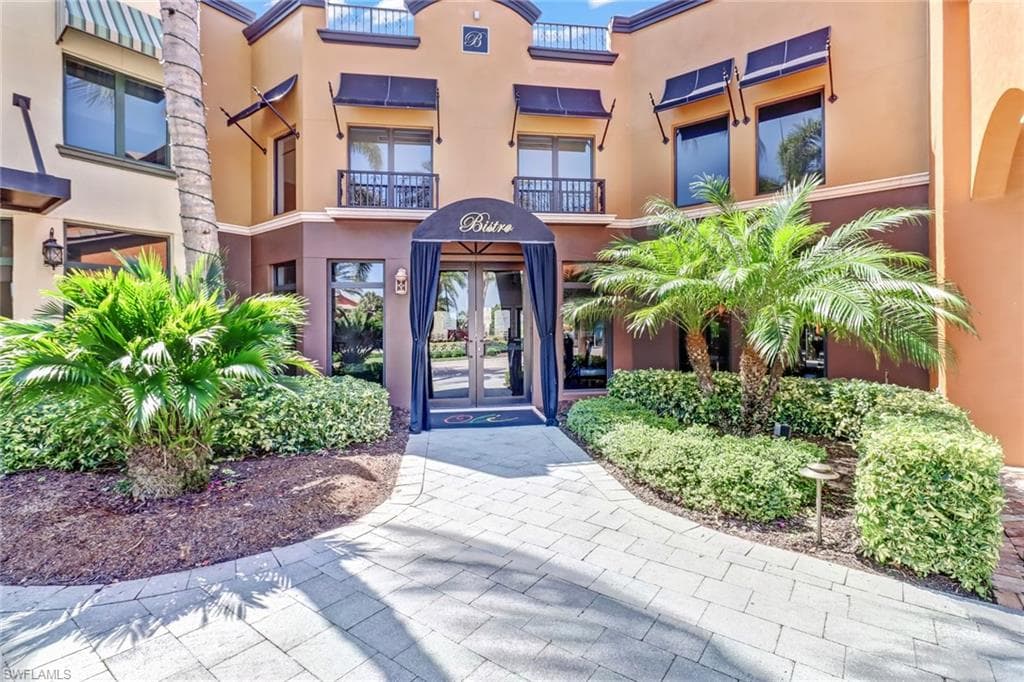 Doorway to property with french doors and stucco siding