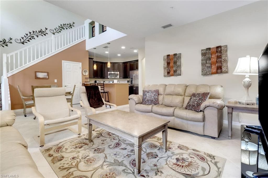 Living area with baseboards, recessed lighting, and light tile patterned floors