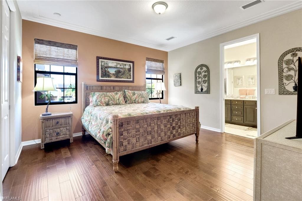 Bedroom featuring ornamental molding, and wood finished floors