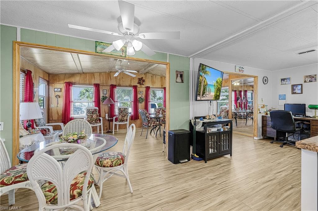 Dining space with visible vents, a ceiling fan, and light wood finished floors