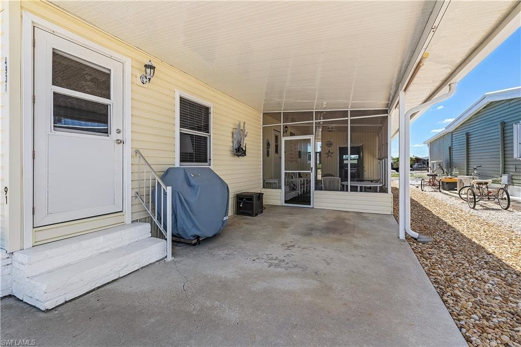 View of patio / terrace with area for grilling, entry steps, and a sunroom