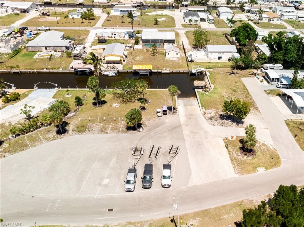 Drone / aerial view with a water view and a residential view