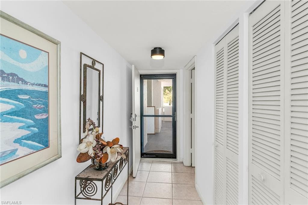 Hall with light tile patterned floors