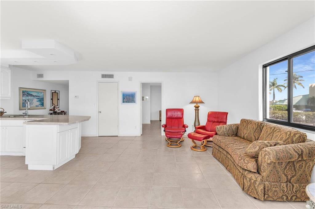 Living area featuring visible vents, baseboards, and light tile patterned flooring