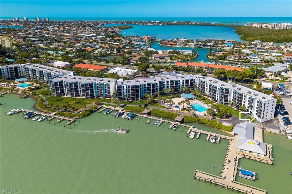 Birds eye view of property with a water view