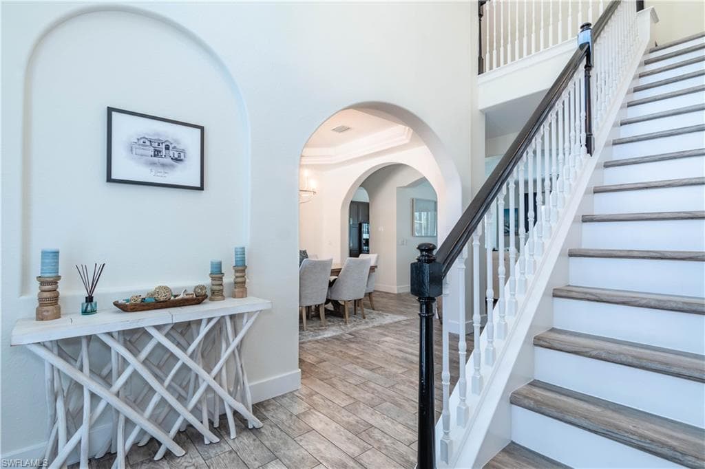 Entrance foyer with stairway and arched walkways
