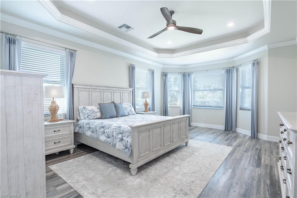 Primary Bedroom featuring a tray ceiling and crown molding