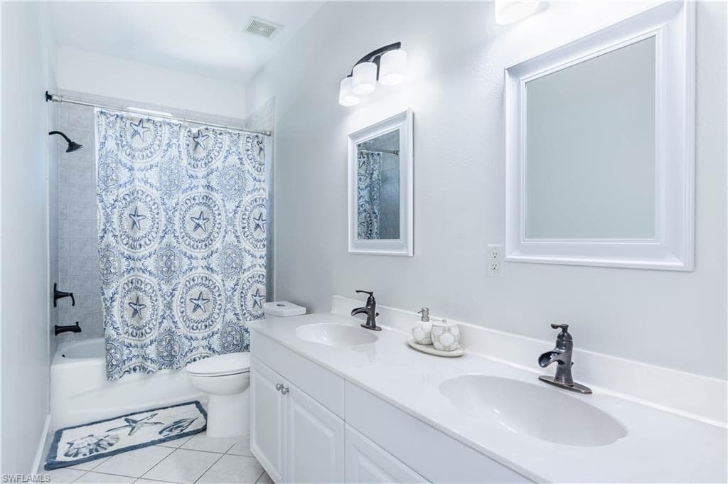 Full bathroom with tile patterned flooring