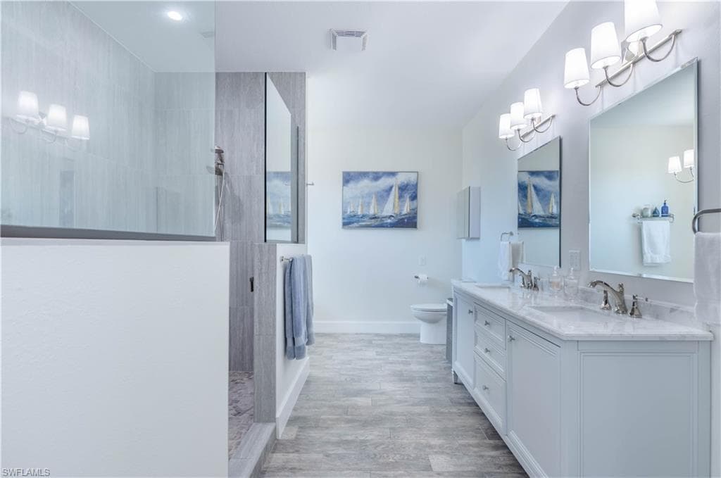 Primary bathroom with a large walk in shower and vanity
