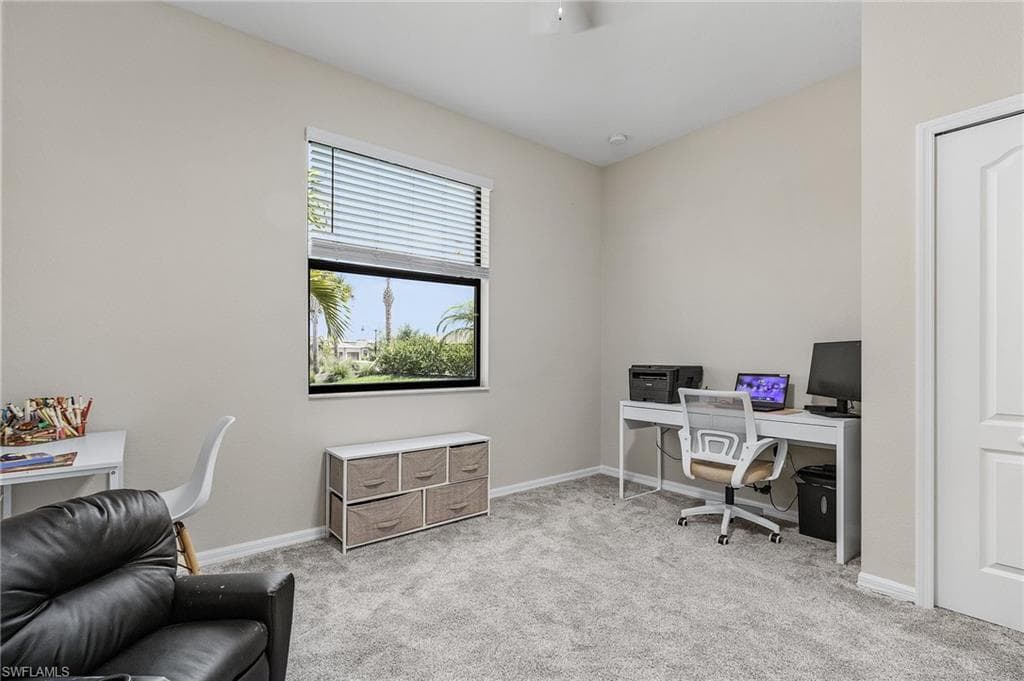 Office with carpet flooring and baseboards